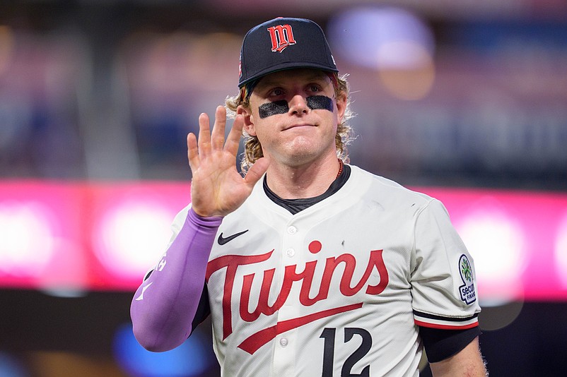Jul 26, 2025; Minneapolis, Minnesota, USA; Minnesota Twins left fielder Harrison Bader (12) waves at a fan while walking to the dugout after the ninth inning against the Washington Nationals at Target Field. Mandatory Credit: Matt Blewett-Imagn Images