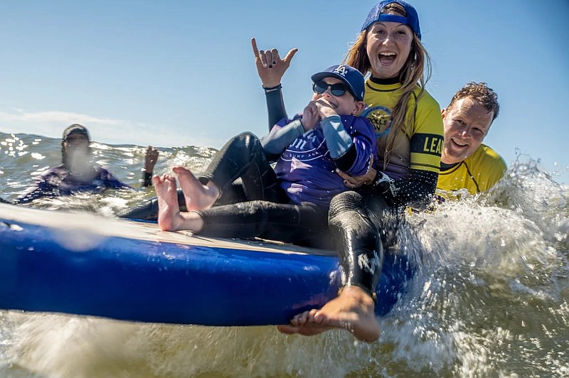 Volunteers and special surfing equipment will help people with disabilities experience the thrill of being out on the ocean. (Photo courtesy of Life Rolls On)