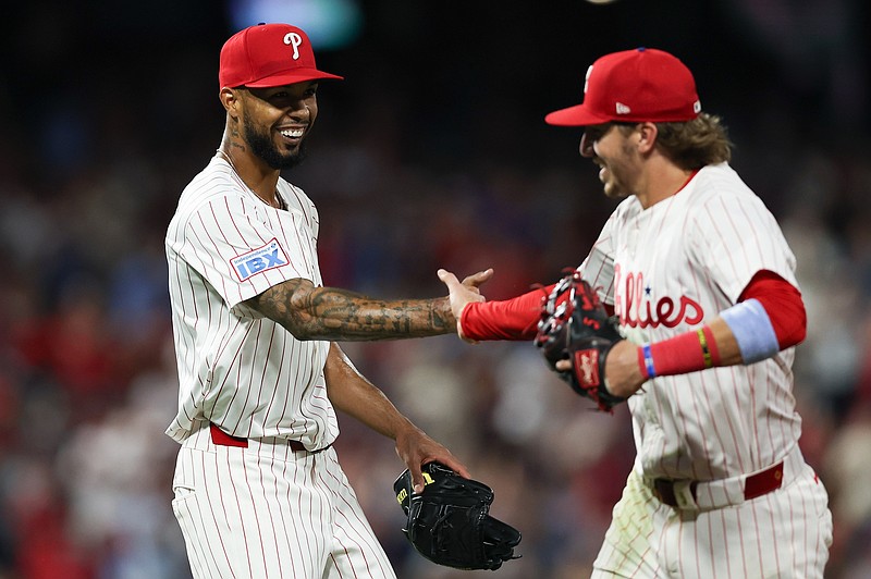 Aug 3, 2025; Philadelphia, Pennsylvania, USA; Philadelphia Phillies pitcher Cristopher Sanchez (L) slaps hands with second base Bryson Stott (R) after his play to end the eighth inning against the Detroit Tigers at Citizens Bank Park. Mandatory Credit: Bill Streicher-Imagn Images