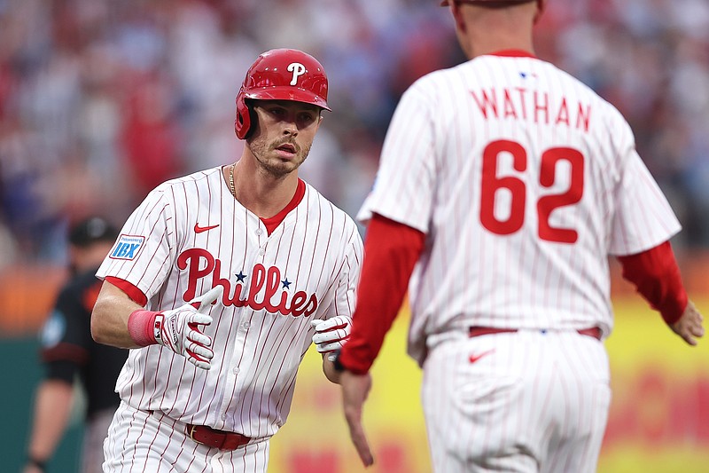 Aug 5, 2025; Philadelphia, Pennsylvania, USA; Philadelphia Phillies outfielder Max Kepler (17) shakes hands with Dusty Wathan while running the bases on his two RBI homer run against the Baltimore Orioles during the second inning at Citizens Bank Park. Mandatory Credit: Bill Streicher-Imagn Images