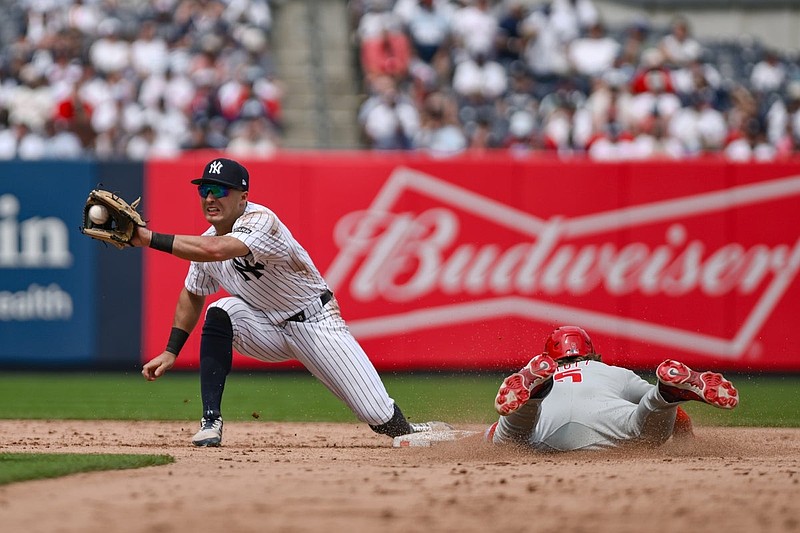 Jul 26, 2025; Bronx, New York, USA; Philadelphia Phillies second baseman Bryson Stott (5) steals second base ahead of the tag by New York Yankees shortstop Anthony Volpe (11) during the sixth inning at Yankee Stadium. Mandatory Credit: John Jones-Imagn Images