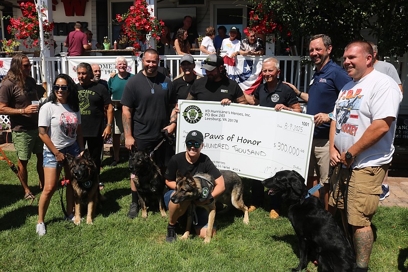 A ceremonial check of $300,000 is presented from Hurricane's Heroes to Paws of Honor for the medical care of retired police and military dogs.