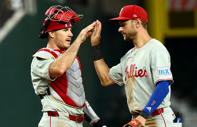 Aug 8, 2025; Arlington, Texas, USA;  Philadelphia Phillies shortstop Trea Turner (7) celebrates with Philadelphia Phillies catcher J.T. Realmuto (10) after the game against the Texas Rangers at Globe Life Field. Mandatory Credit: Kevin Jairaj-Imagn Images