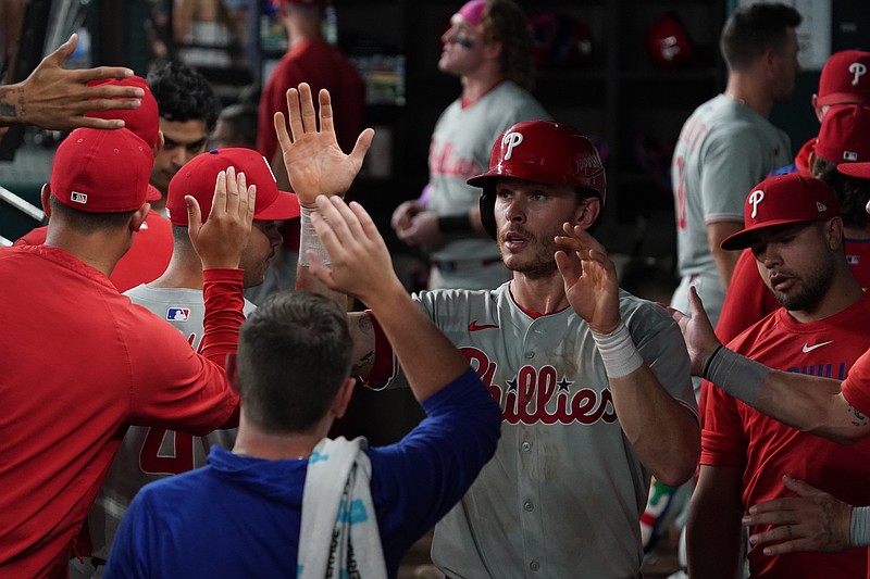Aug 9, 2025; Arlington, Texas, USA; Philadelphia Phillies outfielder Max Kepler (17) is greeted in the dugout after scoring during the seventh inning against the Texas Rangers at Globe Life Field. Mandatory Credit: Raymond Carlin III-Imagn Images