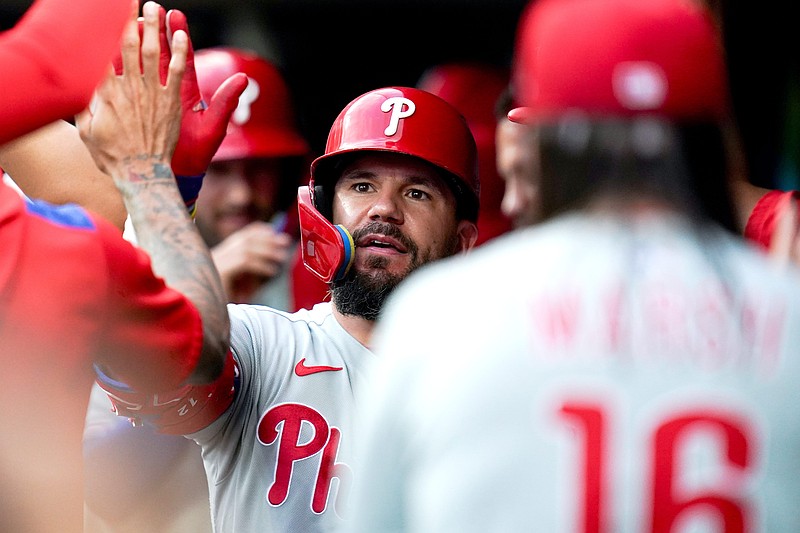 Philadelphia Phillies designated hitter Kyle Schwarber (12) is embraced by his team after scoring a home run in the eighth inning of a MLB game between the Cincinnati Reds and Philadelphia Phillies, Monday, Aug. 11, 2025, at Great American Ball Park in downtown Cincinnati. Phillies won 4-1.