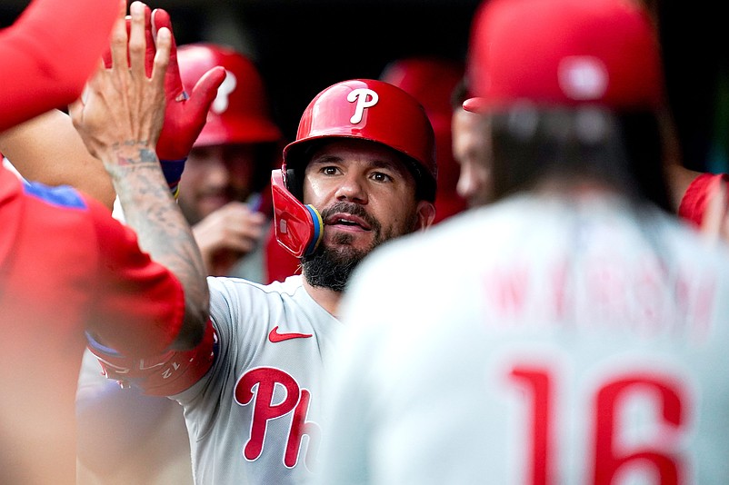 Philadelphia Phillies designated hitter Kyle Schwarber (12) is embraced by his team after scoring a home run in the eighth inning of a MLB game between the Cincinnati Reds and Philadelphia Phillies, Monday, Aug. 11, 2025, at Great American Ball Park in downtown Cincinnati. Phillies won 4-1.