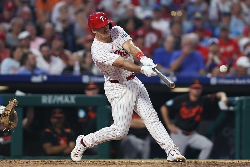 Aug 5, 2025; Philadelphia, Pennsylvania, USA; Philadelphia Phillies catcher J.T. Realmuto (10) hits a single against the Baltimore Orioles during the fifth inning at Citizens Bank Park. Mandatory Credit: Bill Streicher-Imagn Images