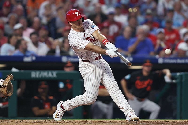 Aug 5, 2025; Philadelphia, Pennsylvania, USA; Philadelphia Phillies catcher J.T. Realmuto (10) hits a single against the Baltimore Orioles during the fifth inning at Citizens Bank Park. Mandatory Credit: Bill Streicher-Imagn Images