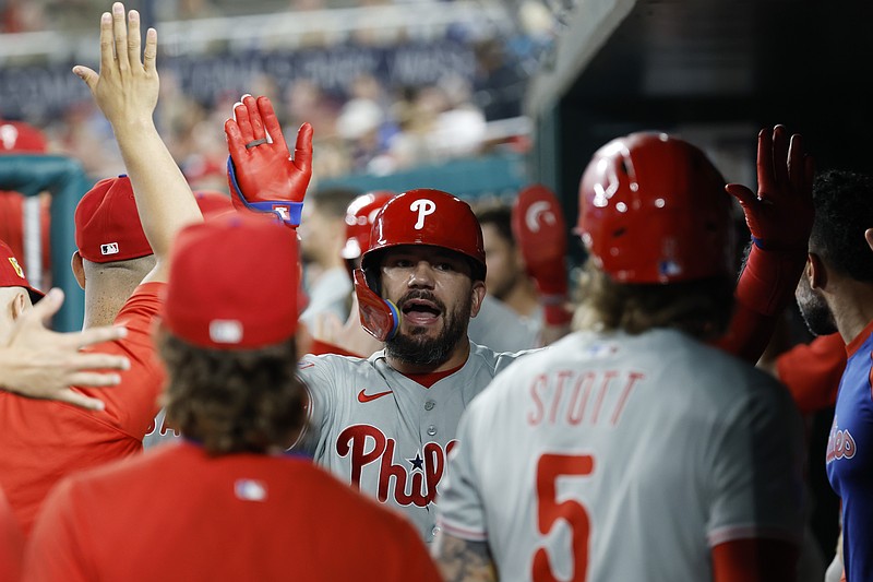 Aug 15, 2025; Washington, District of Columbia, USA; Philadelphia Phillies outfielder Kyle Schwarber (12) celebrates with teammates in the dugout after hitting a three run home run against the Washington Nationals during the seventh inning at Nationals Park. Mandatory Credit: Geoff Burke-Imagn Images