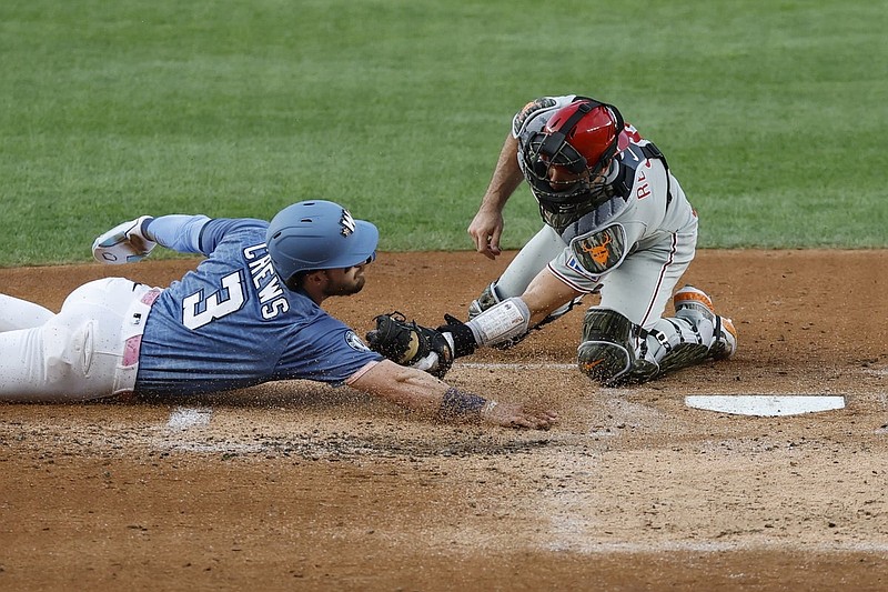 Aug 15, 2025; Washington, District of Columbia, USA; Philadelphia Phillies catcher J.T. Realmuto (10) tags out Washington Nationals outfielder Dylan Crews (3) at home plate during the second inning at Nationals Park. Mandatory Credit: Geoff Burke-Imagn Images