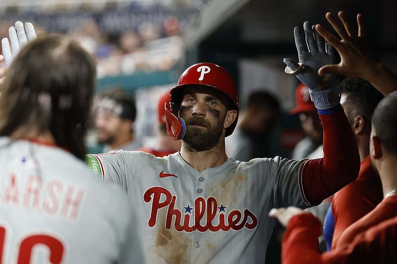Aug 15, 2025; Washington, District of Columbia, USA; Philadelphia Phillies first baseman Bryce Harper (3) celebrates with teammates in the dugout after hitting a solo home run against the Washington Nationals during the seventh inning at Nationals Park. Mandatory Credit: Geoff Burke-Imagn Images