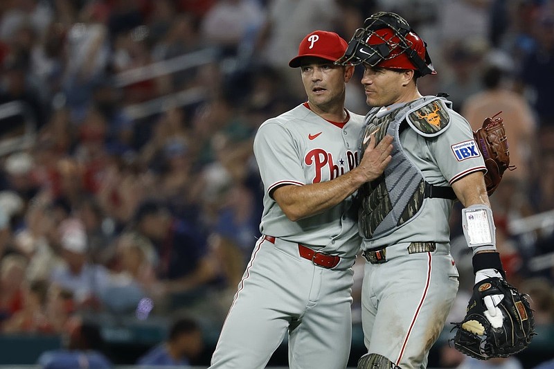 Aug 15, 2025; Washington, District of Columbia, USA; Philadelphia Phillies pitcher David Robertson (30) celebrates with Phillies catcher J.T. Realmuto (10) after their game against the Washington Nationals at Nationals Park. Mandatory Credit: Geoff Burke-Imagn Images