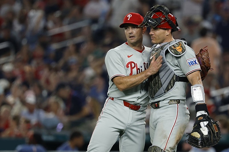 Aug 15, 2025; Washington, District of Columbia, USA; Philadelphia Phillies pitcher David Robertson (30) celebrates with Phillies catcher J.T. Realmuto (10) after their game against the Washington Nationals at Nationals Park. Mandatory Credit: Geoff Burke-Imagn Images
