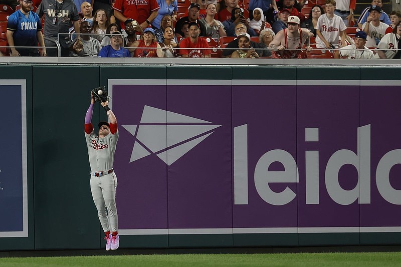 Aug 15, 2025; Washington, District of Columbia, USA; Philadelphia Phillies outfielder Harrison Bader (2) makes a catch of a fly ball hit by Washington Nationals outfielder Daylen Lile (not pictured) during the seventh inning at Nationals Park. Mandatory Credit: Geoff Burke-Imagn Images