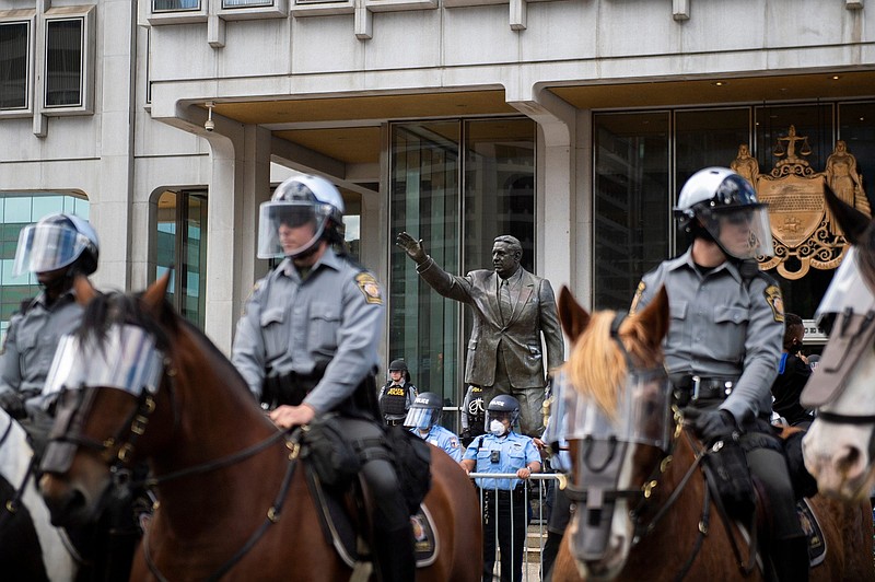 Police officers gather by a recently cleaned Frank Rizzo statue Sunday, May 31, 2020 in Philadelphia, Pa. following the aftermath of Saturday's protests against the killing of George Floyd...Jl Protest 2 53120 25