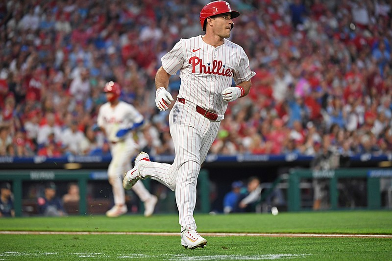 Aug 19, 2025; Philadelphia, Pennsylvania, USA; Philadelphia Phillies catcher J.T. Realmuto (10) hits an RBI single during the third inning against the Seattle Mariners  at Citizens Bank Park. Mandatory Credit: Eric Hartline-Imagn Images