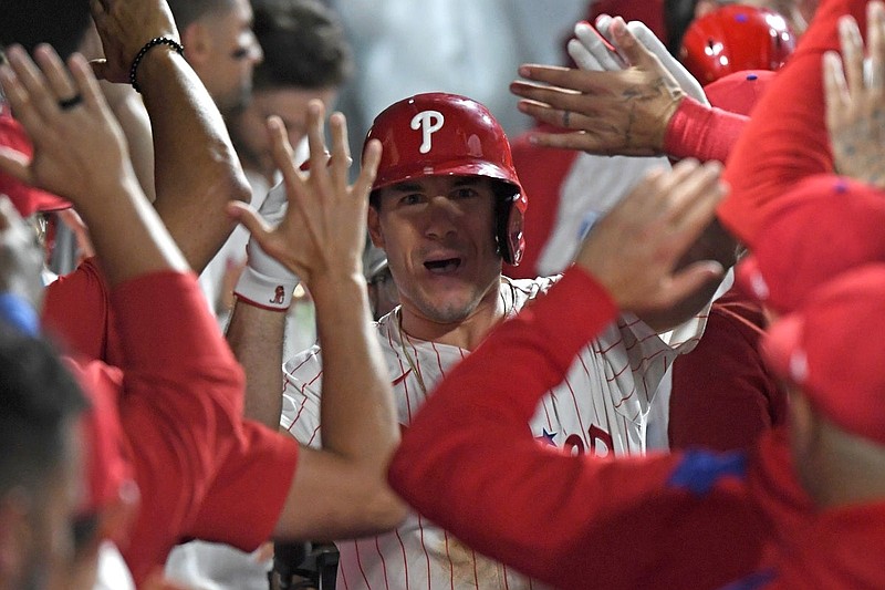 Aug 19, 2025; Philadelphia, Pennsylvania, USA; Philadelphia Phillies catcher J.T. Realmuto (10) celebrates his two-run home run during the eighth inning against the Seattle Mariners in the dugout at Citizens Bank Park. Mandatory Credit: Eric Hartline-Imagn Images