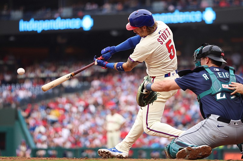 Aug 20, 2025; Philadelphia, Pennsylvania, USA; Philadelphia Phillies second base Bryson Stott (5) hits an RBI double during the second inning against the Seattle Mariners at Citizens Bank Park. Mandatory Credit: Bill Streicher-Imagn Images