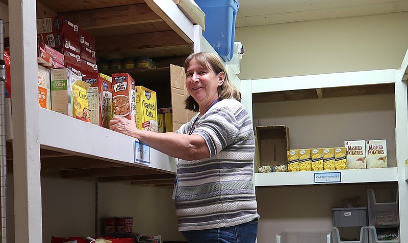 PROVIDED/JFS Food pantry associate Lauren D’Agostino organizes donated boxes of cereal in the pantry.