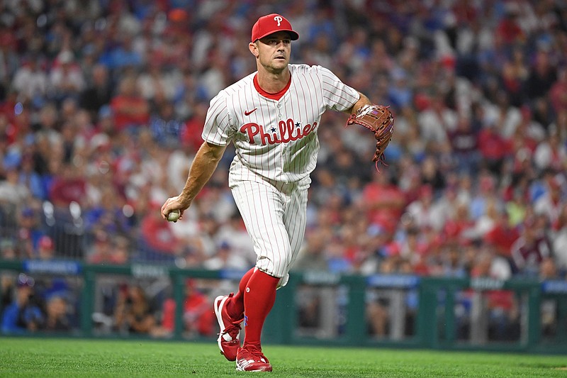 Aug 19, 2025; Philadelphia, Pennsylvania, USA; Philadelphia Phillies pitcher David Robertson (30) flips the ball to first base during the eighth inning against the Seattle Mariners at Citizens Bank Park. Mandatory Credit: Eric Hartline-Imagn Images