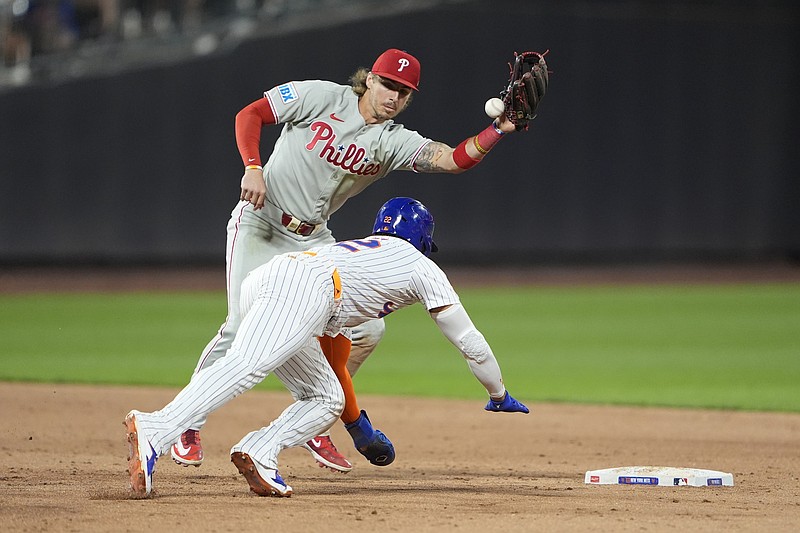 Aug 25, 2025; New York City, New York, USA; New York Mets right fielder Juan Soto (22) steals second base with Philadelphia Phillies second baseman Bryson Stott (5) missing the throw during the fifth inning at Citi Field. Mandatory Credit: Gregory Fisher-Imagn Images