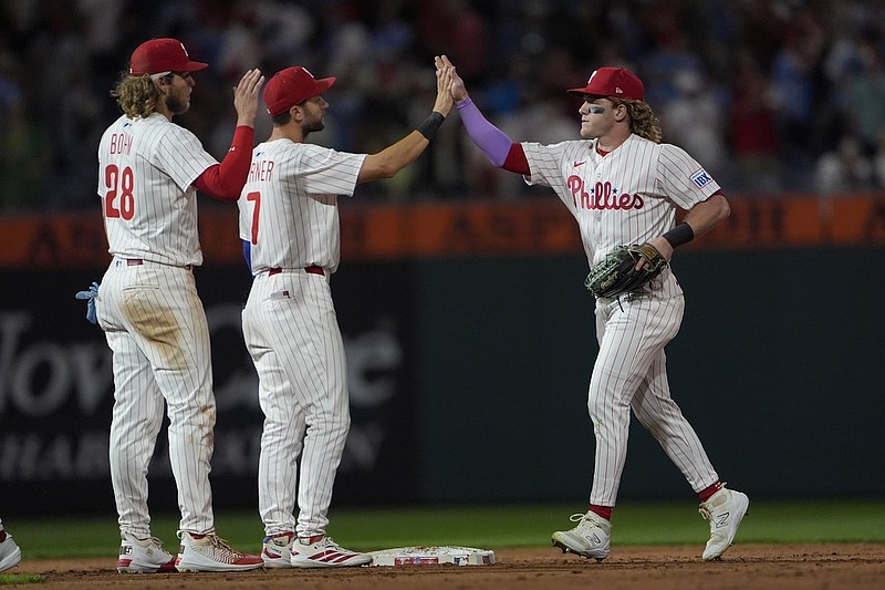 Aug 23, 2025; Philadelphia, Pennsylvania, USA; Philadelphia Phillies shortstop Trea Turner (7) and left fielder Harrison Bader (2) hi five to celebrate the victory along with third baseman Alec Bohm (28) after the ninth inning against the Washington Nationals at Citizens Bank Park. Mandatory Credit: Gregory Fisher-Imagn Images