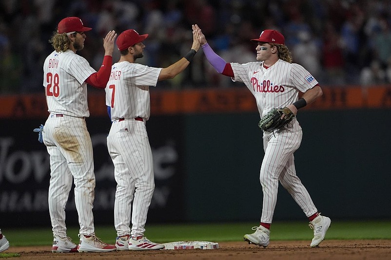 Aug 23, 2025; Philadelphia, Pennsylvania, USA; Philadelphia Phillies shortstop Trea Turner (7) and left fielder Harrison Bader (2) hi five to celebrate the victory along with third baseman Alec Bohm (28) after the ninth inning against the Washington Nationals at Citizens Bank Park. Mandatory Credit: Gregory Fisher-Imagn Images