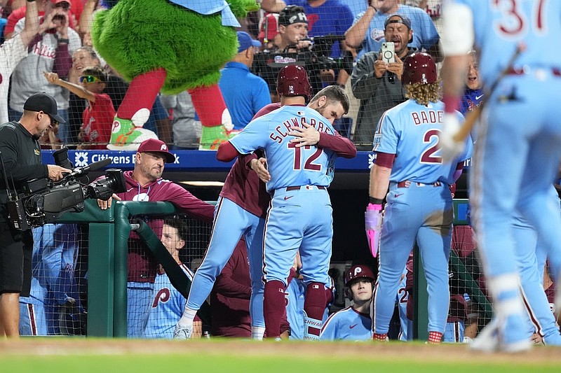 Aug 28, 2025; Philadelphia, Pennsylvania, USA; Philadelphia Phillies designated hitter Kyle Schwarber (12) reacts with infielder Bryce Harper (3) after hitting a three-run home run against the Atlanta Braves in the seventh inning at Citizens Bank Park. Mandatory Credit: Kyle Ross-Imagn Images