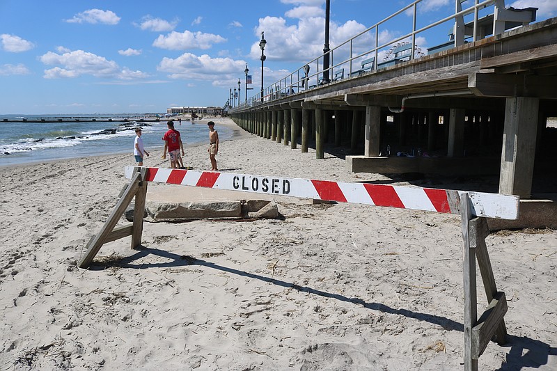 A "Closed" sign serves as a barricade to the badly eroded beach at 5th Street in Ocean City.