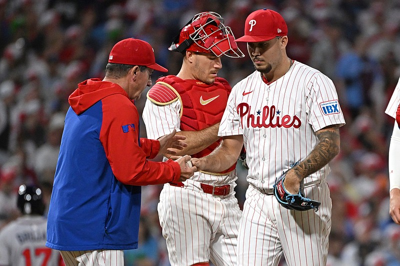 Aug 31, 2025; Philadelphia, Pennsylvania, USA; Philadelphia Phillies pitcher Orion Kerkering (50) hands the ball to Philadelphia Phillies manager Rob Thomson (49) during the eighth inning against the Atlanta Braves at Citizens Bank Park. Mandatory Credit: Eric Hartline-Imagn Images