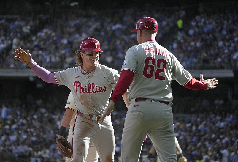 Sep 1, 2025; Milwaukee, Wisconsin, USA; Philadelphia Phillies outfielder Harrison Bader (2) celebrates hitting a double when he got to third base with Philadelphia Phillies third base coach Dusty Wathan (62) against the Milwaukee Brewers in the sixth inning at American Family Field. Mandatory Credit: Michael McLoone-Imagn Images