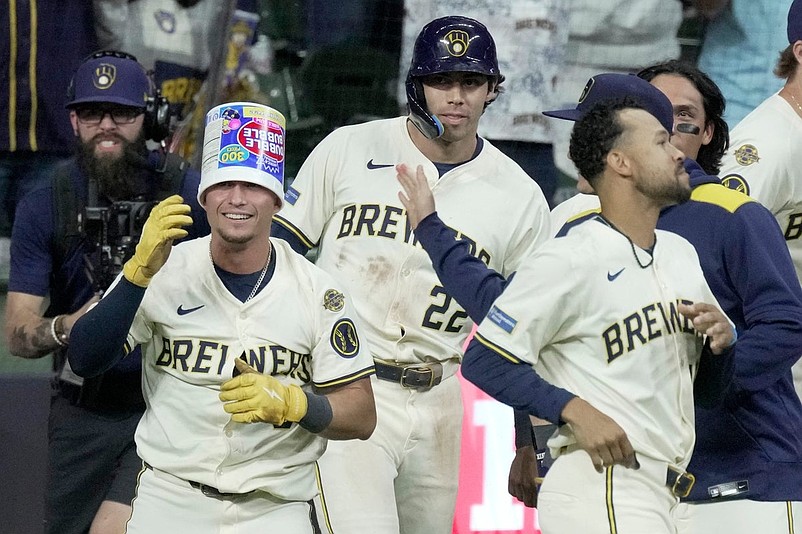 Milwaukee Brewers outfielder Isaac Collins (6) is swarmed by teammates after hitting a game-winning sacrifice fly during the ninth inning of their game against the Arizona Diamondbacks Tuesday, August 26, 2025 at American Family Field in Milwaukee, Wisconsin. The Milwaukee Brewers beat the Arizona Diamondbacks 9-8.