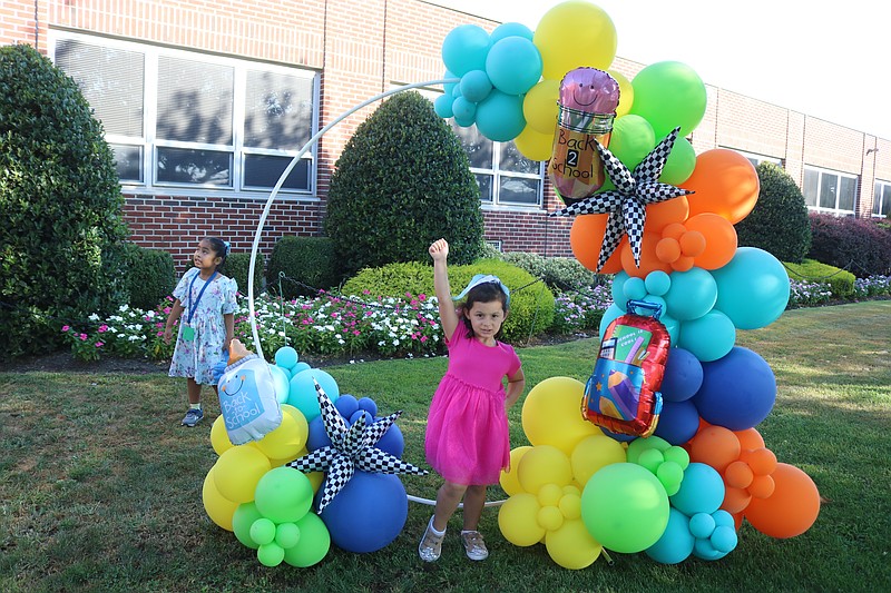 Maddie Marrero, 4, a pre-kindergarten student, has some fun in a colorful display of balloons.