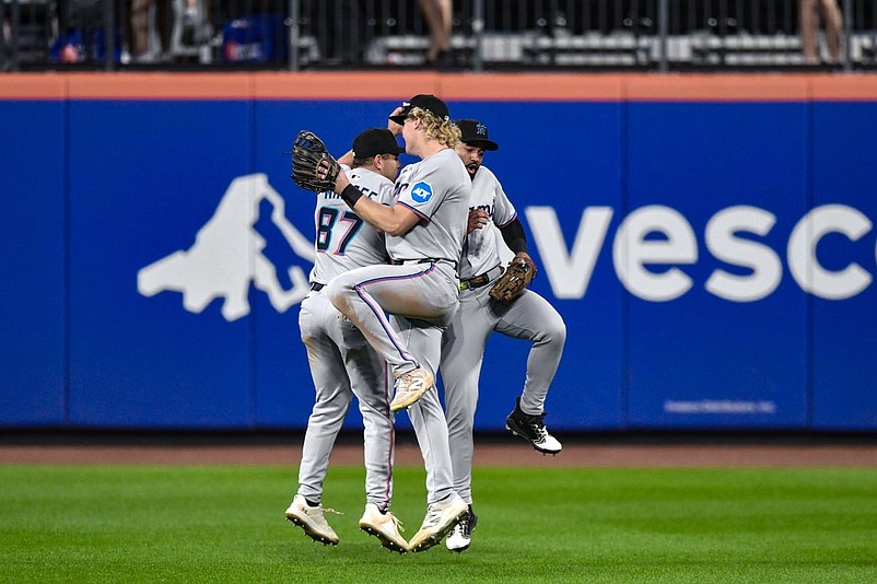 Aug 30, 2025; New York City, New York, USA; Miami Marlins outfielders Jakob Marsee (87), Joey Wiemer (41) and Derek Hill (3) celebrate after winning the game against the New York Mets at Citi Field. Mandatory Credit: John Jones-Imagn Images
