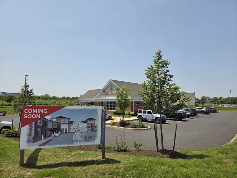 A “Coming soon” sign shows a rendering of possible development within a long-vacant shopping center on Forty Foot Road in Towamencin on Wednesday, June 4, 2025.