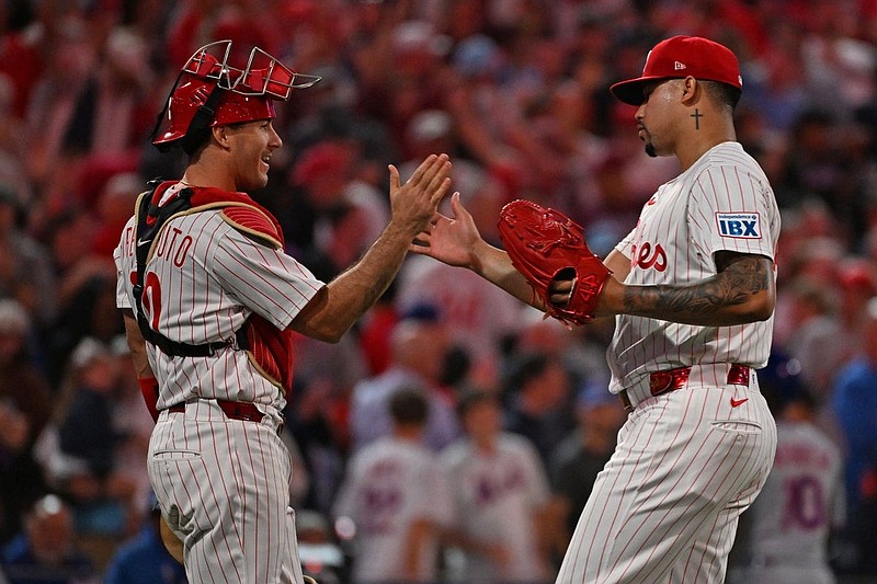 Sep 8, 2025; Philadelphia, Pennsylvania, USA; Philadelphia Phillies catcher J.T. Realmuto (10) and pitcher Jhoan Duran (59) celebrate win against the New York Mets at Citizens Bank Park. Mandatory Credit: Eric Hartline-Imagn Images