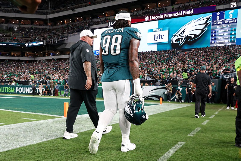 Sep 4, 2025; Philadelphia, Pennsylvania, USA; Philadelphia Eagles defensive tackle Jalen Carter (98) walks off the field with Eagles chief security officer Dom DiSandro (L) after being ejected from the game against the Dallas Cowboys at Lincoln Financial Field. Mandatory Credit: Bill Streicher-Imagn Images