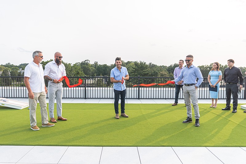Members of the ownership group of the Landmark at Dublin cut the ribbon. Left to Right: Michael DeMaio Sr. (Milex Construction), Steve Bohn (Milex Construction), Antonio DiCianni(Suburban City Group), Michael DeMaio Jr. (Milex Construction), Background: Mayor Chris Hayes (Credit: Happenings Media)