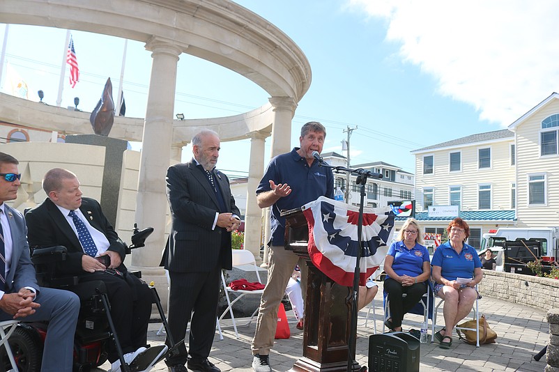 John Kostick, at podium, recounts how he survived the 9/11 attacks on the World Trade Center in New York City.