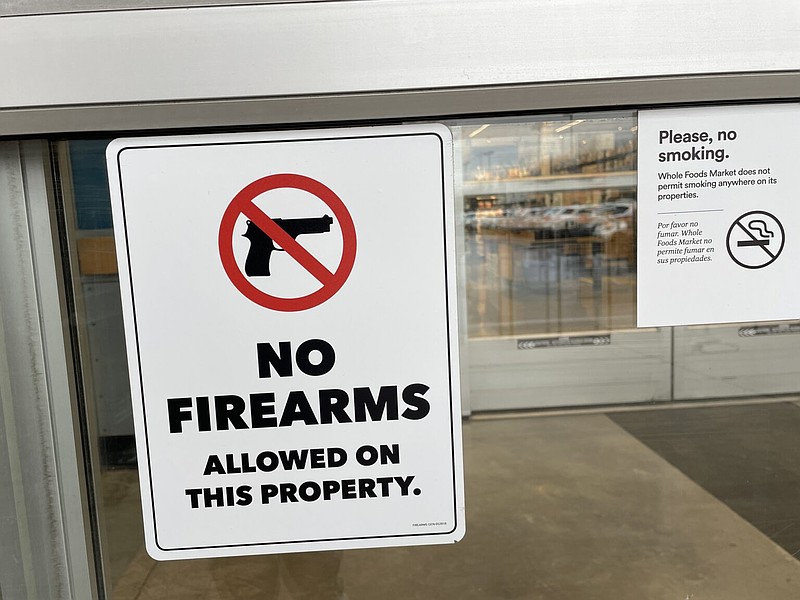 A sign warns shoppers at the Whole Foods Market in Princeton not to bring guns inside the store. (Dana DiFilippo | New Jersey Monitor)