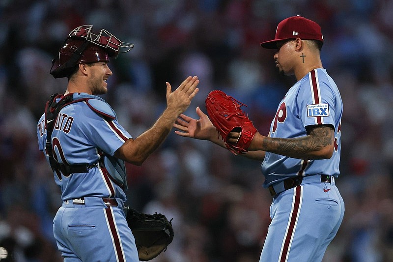Sep 11, 2025; Philadelphia, Pennsylvania, USA; Philadelphia Phillies pitcher Jhoan Duran (59) and catcher J.T. Realmuto (10) shake hands after a win against the New York Mets at Citizens Bank Park. Mandatory Credit: Bill Streicher-Imagn Images