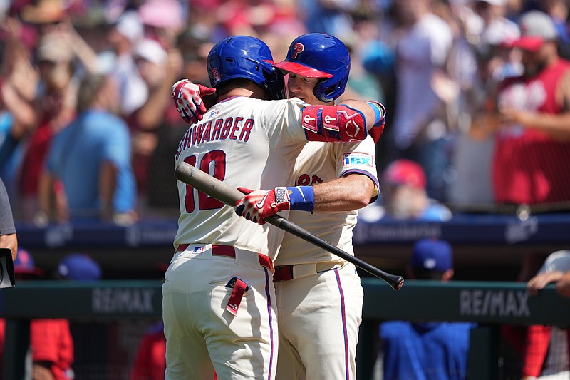 Sep 14, 2025; Philadelphia, Pennsylvania, USA; Philadelphia Phillies designated hitter Kyle Schwarber (12) reacts with catcher J.T. Realmuto (10) after hitting a home run against the Kansas City Royals in the first inning at Citizens Bank Park. Mandatory Credit: Kyle Ross-Imagn Images