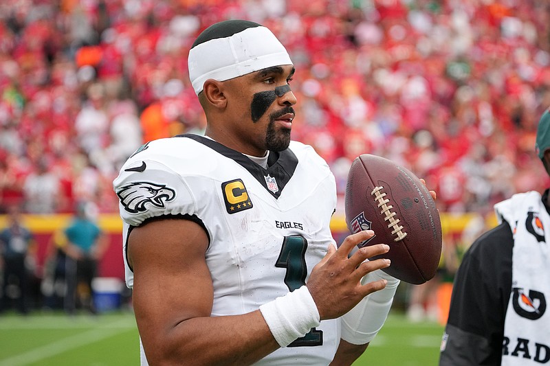 Sep 14, 2025; Kansas City, Missouri, USA; Philadelphia Eagles quarterback Jalen Hurts (1) looks on from the sidelines during the second quarter of the game against the Kansas City Chiefs at GEHA Field at Arrowhead Stadium. Mandatory Credit: Denny Medley-Imagn Images
