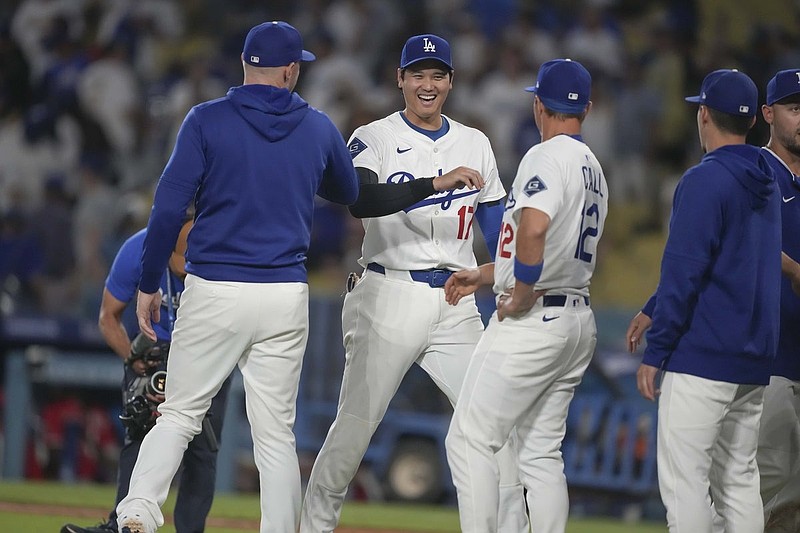 Aug 27, 2025; Los Angeles, California, USA; Los Angeles Dodgers starting pitcher Shohei Ohtani (17) is congratulated by outfielder Alex Call (12) on the win against the Cincinnati Reds at Dodger Stadium. Mandatory Credit: Kirby Lee-Imagn Images