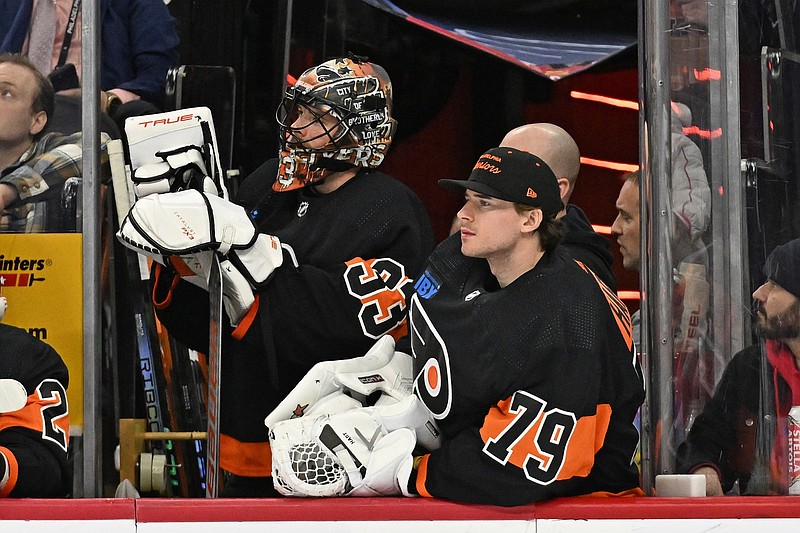 Jan 21, 2024; Philadelphia, Pennsylvania, USA;  Philadelphia Flyers goaltender Samuel Ersson (33) and goaltender Carter Hart (79) watch from the bench against the Ottawa Senators during the third period at Wells Fargo Center. Mandatory Credit: Eric Hartline-USA TODAY Sports
