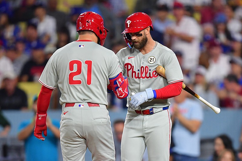 Sep 15, 2025; Los Angeles, California, USA; Philadelphia Phillies outfielder Kyle Schwarber (12) reacts with  first base Bryce Harper (21) in the first inning at Dodger Stadium. Mandatory Credit: Gary A. Vasquez-Imagn Images