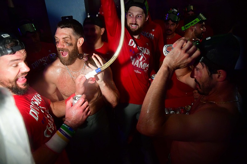 Sep 15, 2025; Los Angeles, California, USA; First baseman Bryce Harper (3) and the Philadelphia Phillies celebrate after clinching the Nationall League East division title at Dodger Stadium. Mandatory Credit: Gary A. Vasquez-Imagn Images