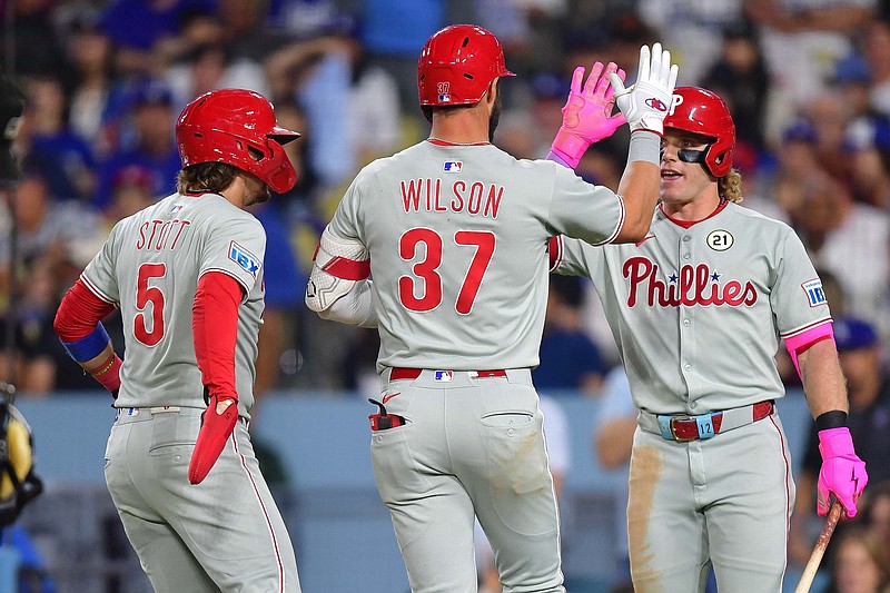 Sep 15, 2025; Los Angeles, California, USA; Philadelphia Phillies second baseman Weston Wilson (37) is greeted by shortstop Bryson Stott (5) and center fielder Harrison Bader (2) after hitting a two run home run against the Los Angeles Dodgers during the seventh inning at Dodger Stadium. Mandatory Credit: Gary A. Vasquez-Imagn Images