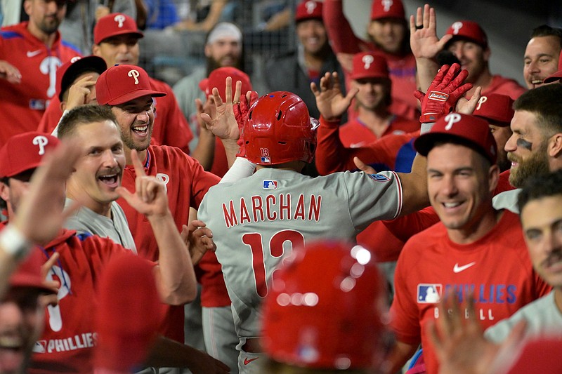 Sep 16, 2025; Los Angeles, California, USA;  Philadelphia Phillies catcher Rafael Marchan (13) celebrates with in the dugout after hitting a 3-run home run in the ninth inning against the Los Angeles Dodgers at Dodger Stadium. Mandatory Credit: Jayne Kamin-Oncea-Imagn Images