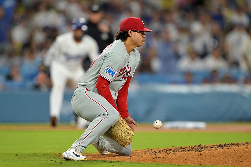Sep 17, 2025; Los Angeles, California, USA; Philadelphia Phillies pitcher Jesus Luzardo (44) fields a ball against the Los Angeles Dodgers in the second inning at Dodger Stadium. Mandatory Credit: Jayne Kamin-Oncea-Imagn Images